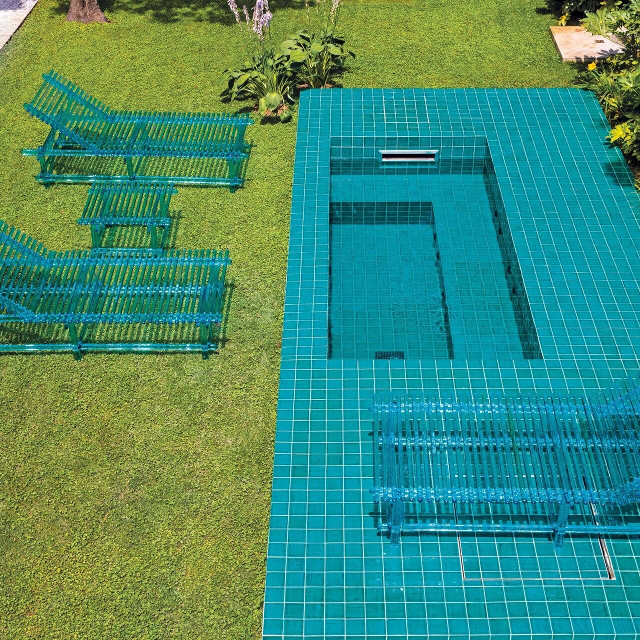   A'mare . I lettini e il tavolino a bordo piscina. 